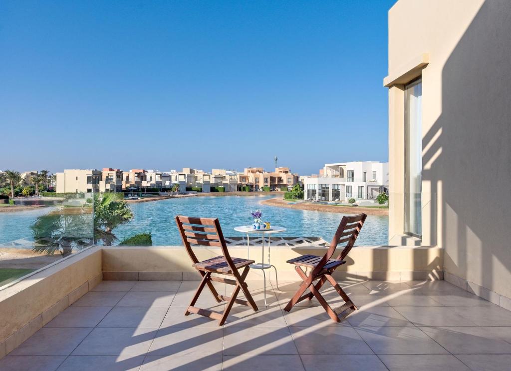 a patio with two chairs and a table on a balcony at Vesta - El Gouna Residence in Hurghada