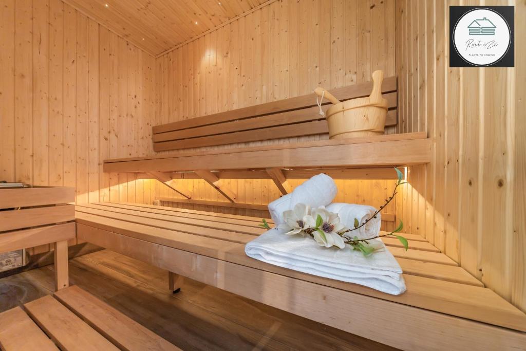a sauna with a bouquet of flowers on a towel at Romantic getaway UK with Private Sauna, King Bed, WiFi 517mbps & EV Charger in Woking