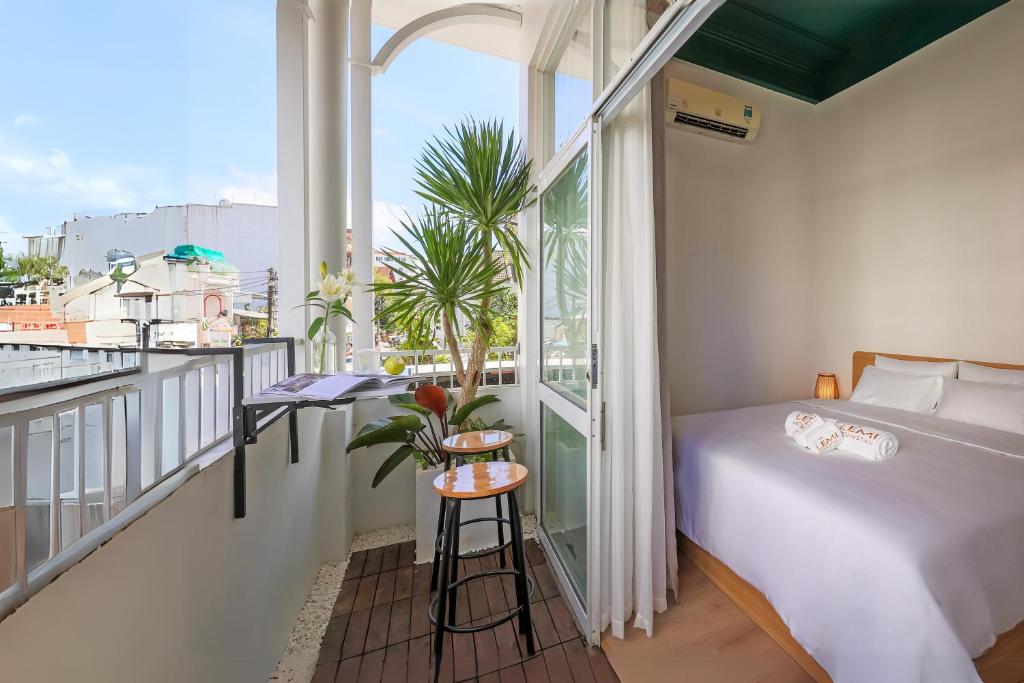 a bedroom with a bed and a balcony at Lemi - Homestay in Hue in Hue