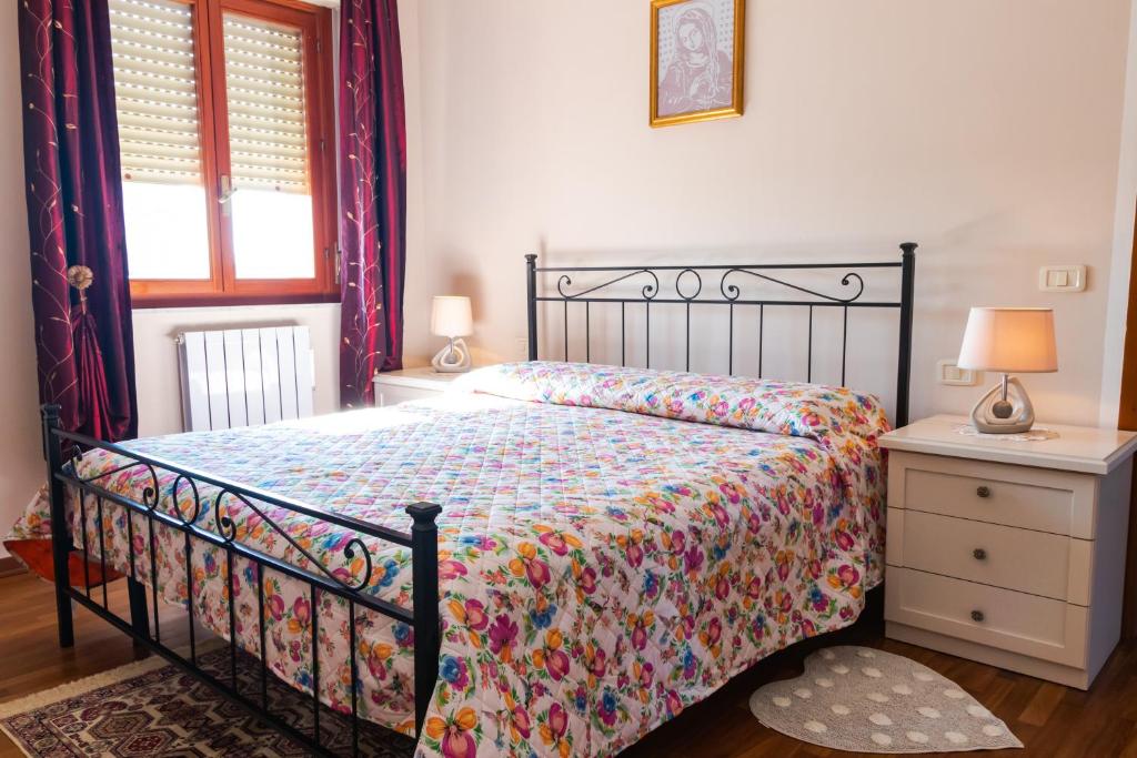 a bedroom with a bed and a table and a window at Casa Vacanze "Ai piedi di Assisi" in Bastia Umbra