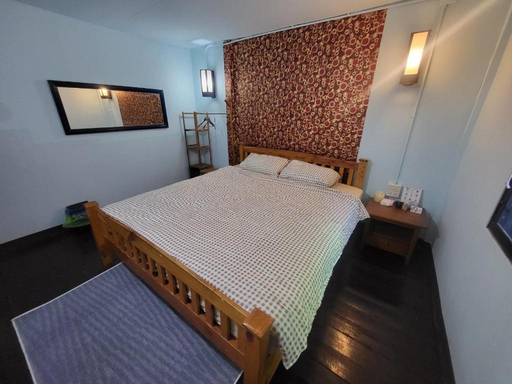 a bedroom with a wooden bed and a mirror at Punkei home-Chiang Mai Center Near Sunday Market in Chiang Mai