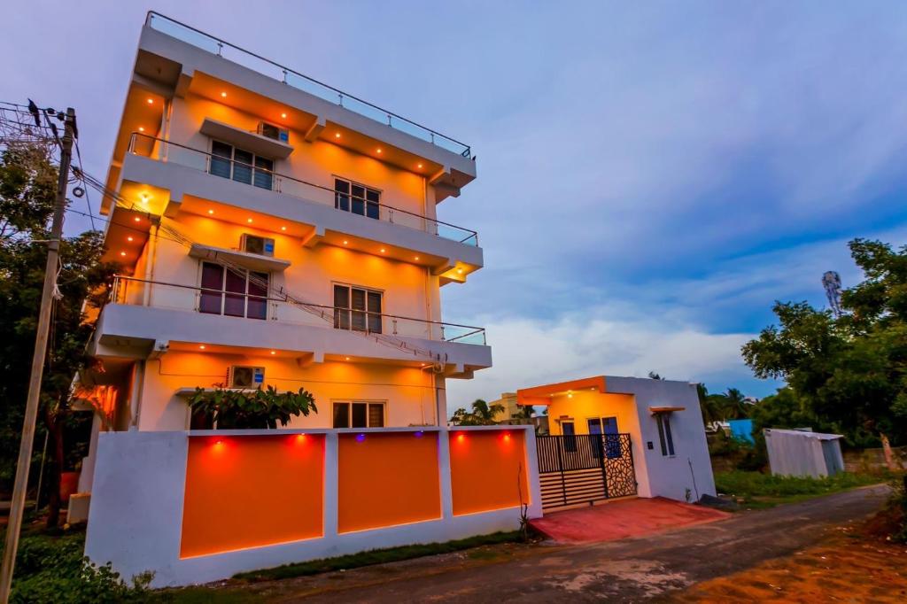 a white house with lights on the side of it at 1BHK villa with swimming pool @ Dreamland in Kottakupam