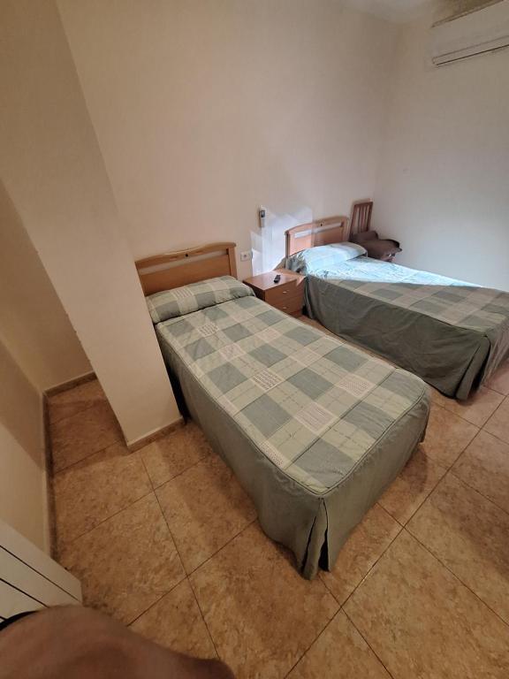 a room with two beds in a room at Hostal Pension - La Rotonda in Tardienta