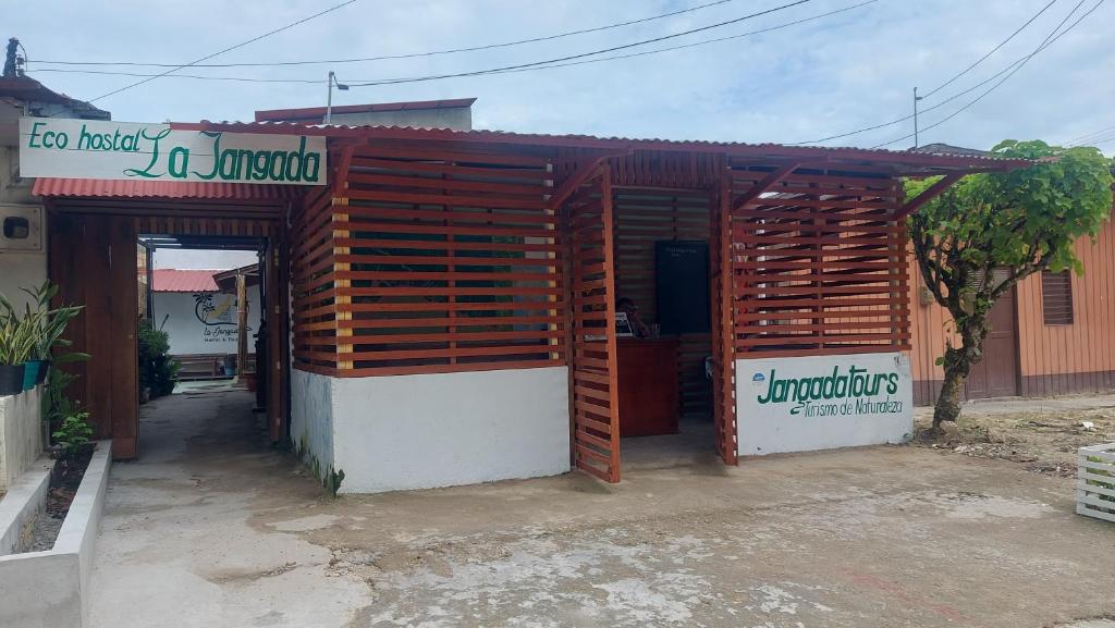 a small building with a sign on top of it at La Jangada Hostel & Tours in Leticia