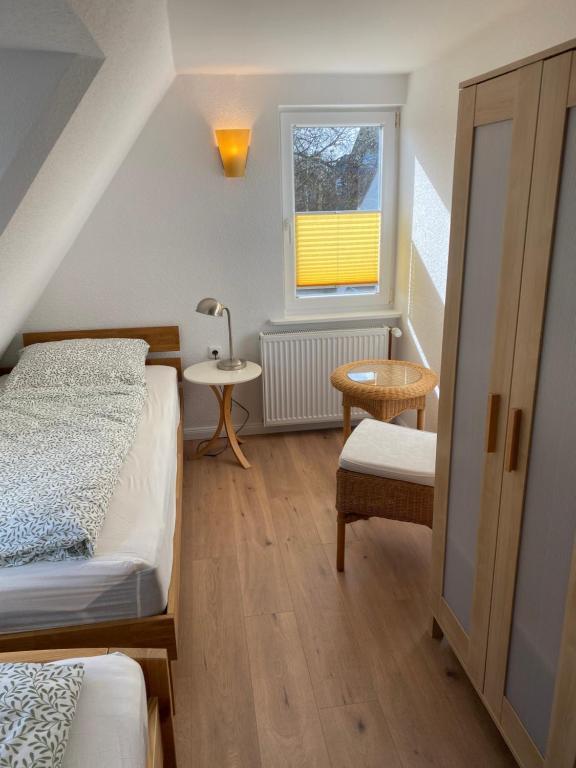 a small room with two beds and a window at Sofort am Strand! in Kiel