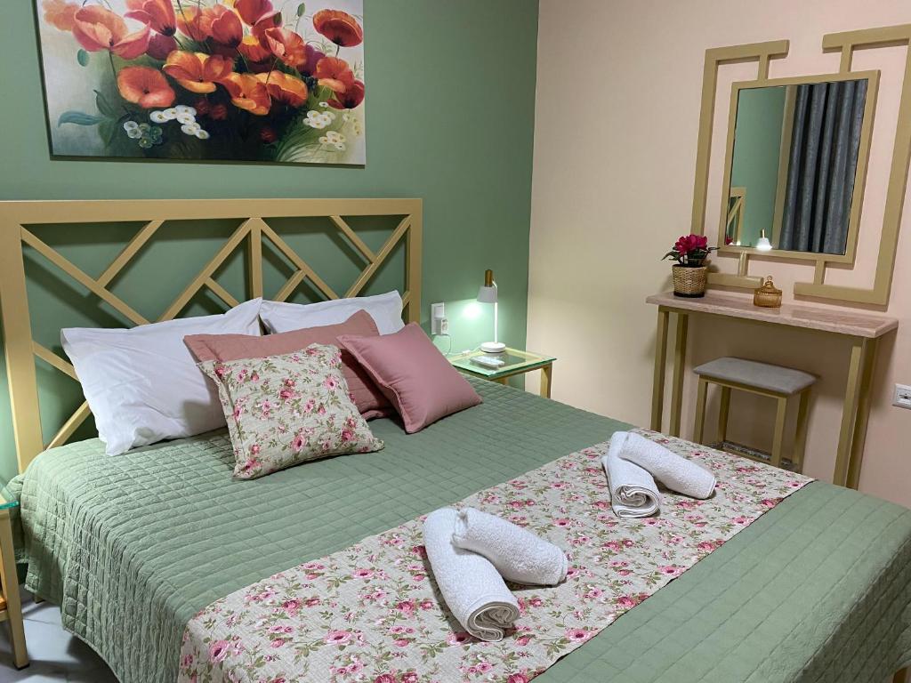 una camera da letto con un letto e due pantofole sopra di Anastasia's Luxury House a Kavala