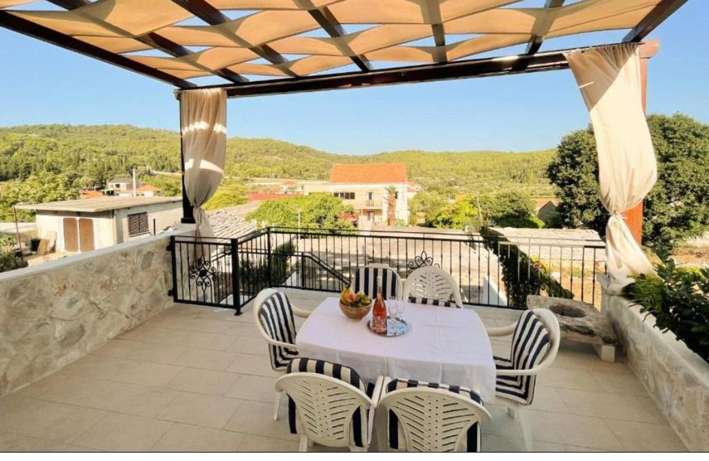 a patio with a table and chairs on a balcony at Peaceful home in old village in Korčula