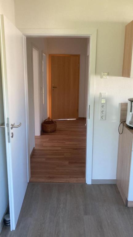 an empty room with a hallway leading to a door at Ferienwohnung Christel in Erlenbach am Main