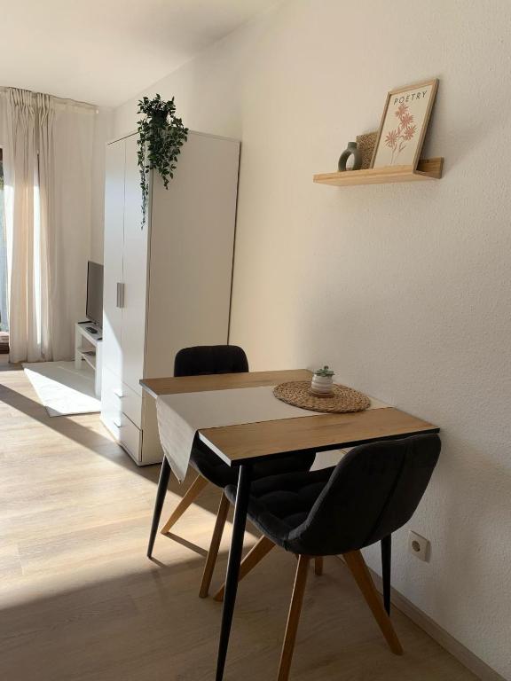 a dining room with a table and two chairs at Ferienwohnung Panorama Schwarzwald in Herrischried
