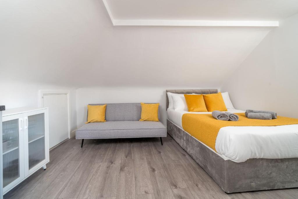 a bedroom with a bed and a chair at Cosy 4th Floor studio apartment in Brick Lane in London