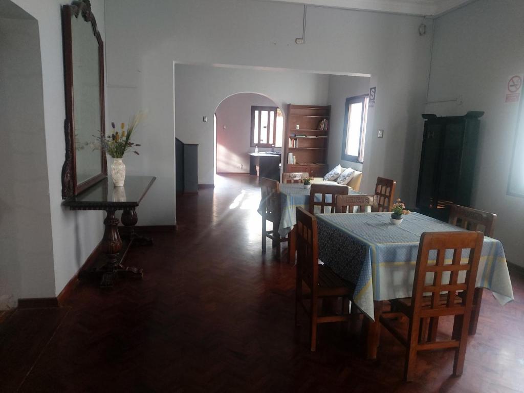 a dining room with a table and chairs and a mirror at Global Family Backpackers Hostel in Lima