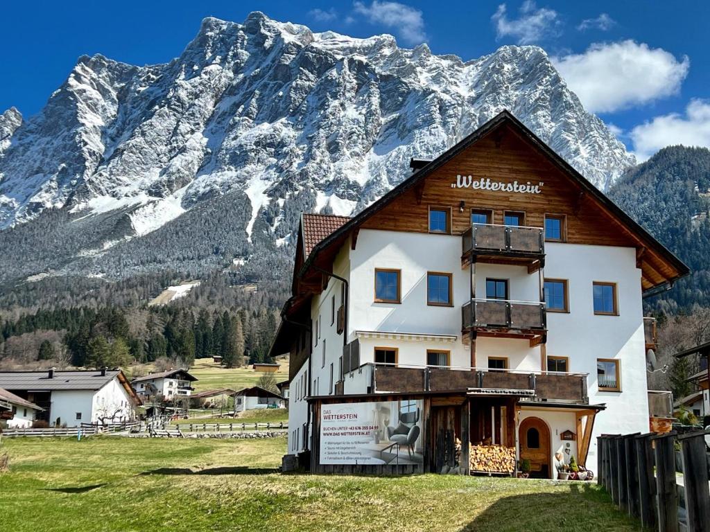 a building in front of a snow covered mountain at Das Wetterstein in Ehrwald