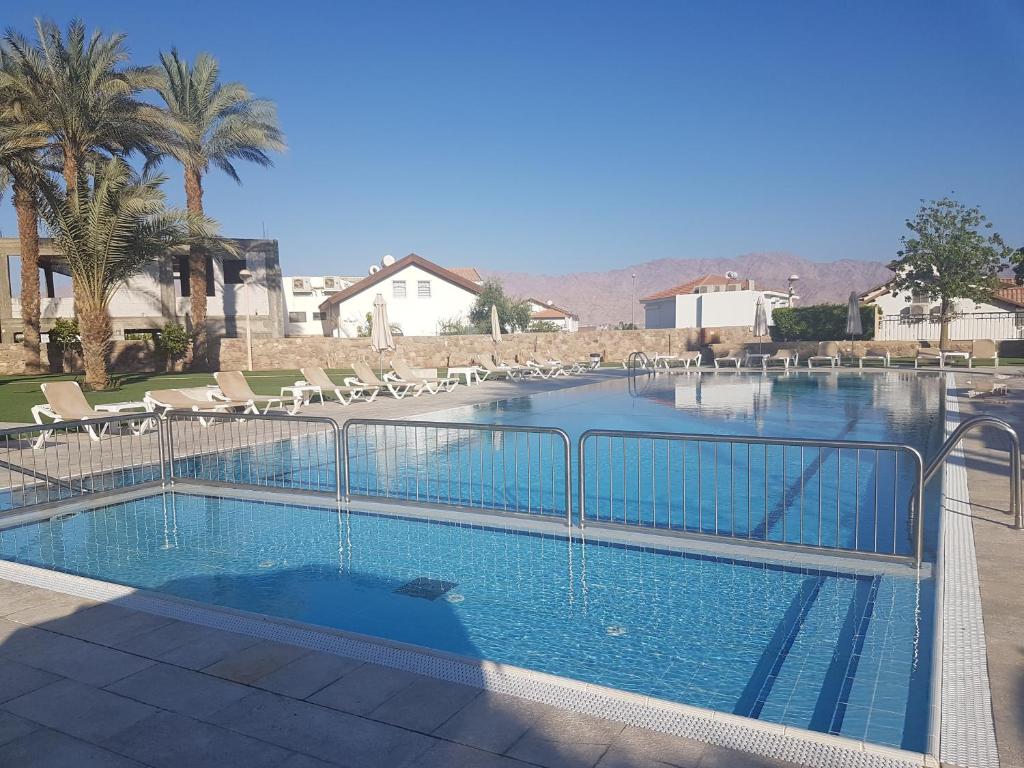 a large swimming pool with a fence around it at Luxury Exclusive Аmdar Resort with Pool Jim Near the Sea שדרות הארגמן 28 in Eilat