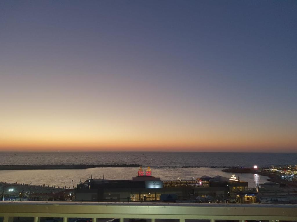 a view of the ocean at sunset from a building at City Square in Alexandria