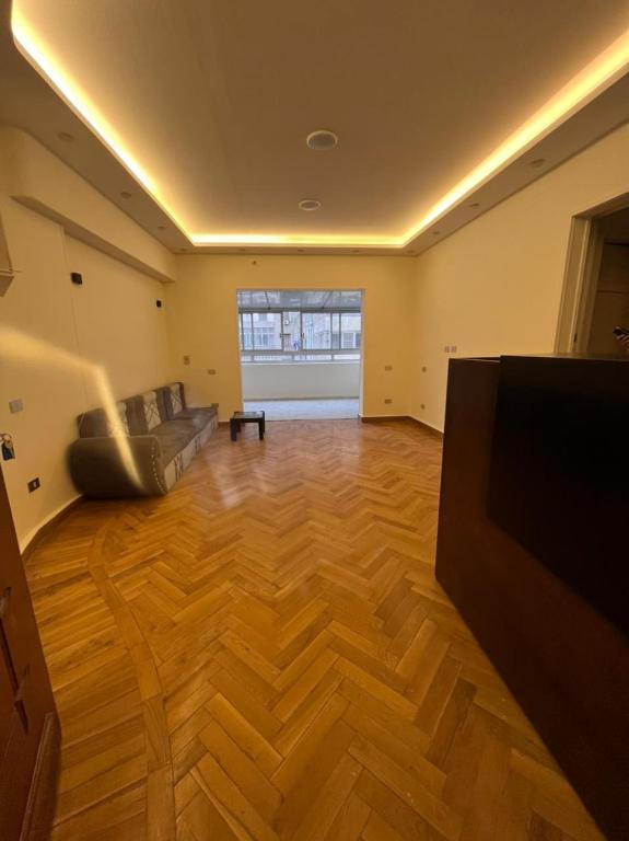 a living room with a couch and a flat screen tv at Cairo de casa hostel in Cairo