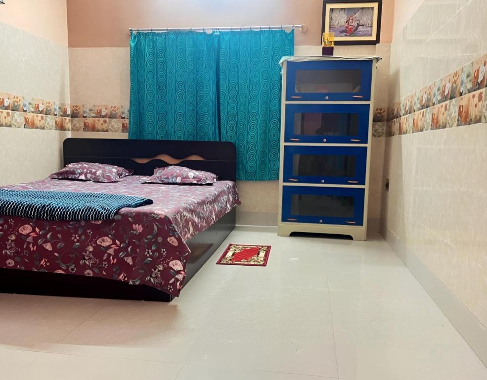 een slaapkamer met een bed en een blauwe dressoir bij Peaceful Spacious Private 1BHK Near Airport close to VIP or Jessore Rd in Nagarbazar