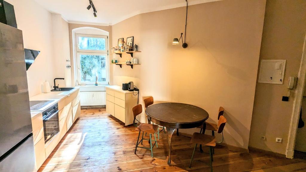 a kitchen with a table and chairs in a room at vice • the heart of friedrichshain in Berlin