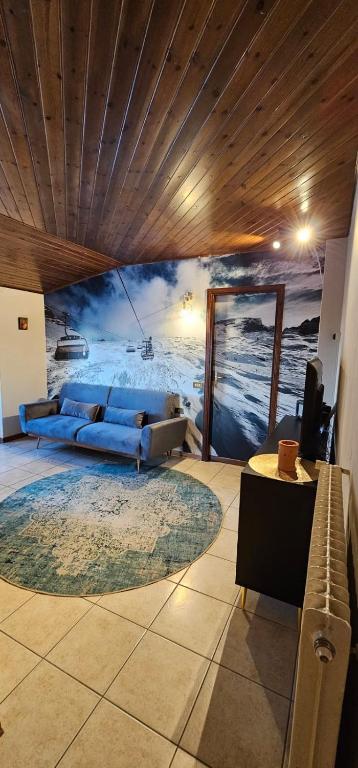 a living room with a couch and a painting on the wall at La Baita Residence 3.0 in Folgarida