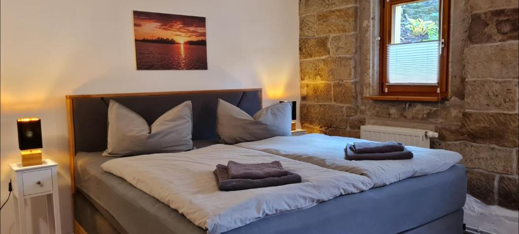 a large bed with two pillows on top of it at Ferienwohnung am Bächelweg in Bad Schandau