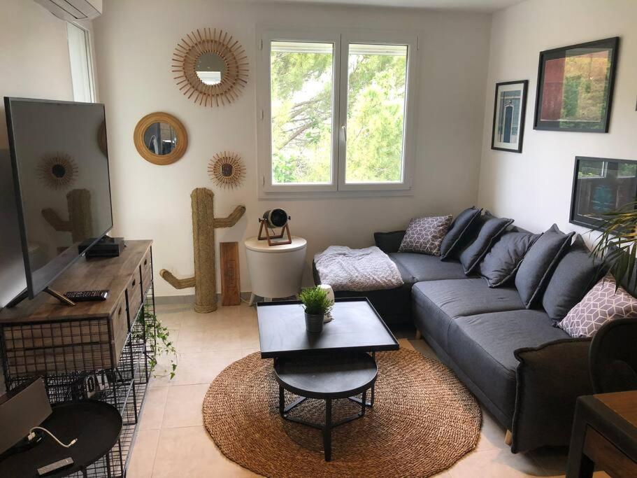 un salon avec un canapé et une table dans l'établissement Appartement 3chambres/parking proche MONTPELLIER, à Castelnau-le-Lez
