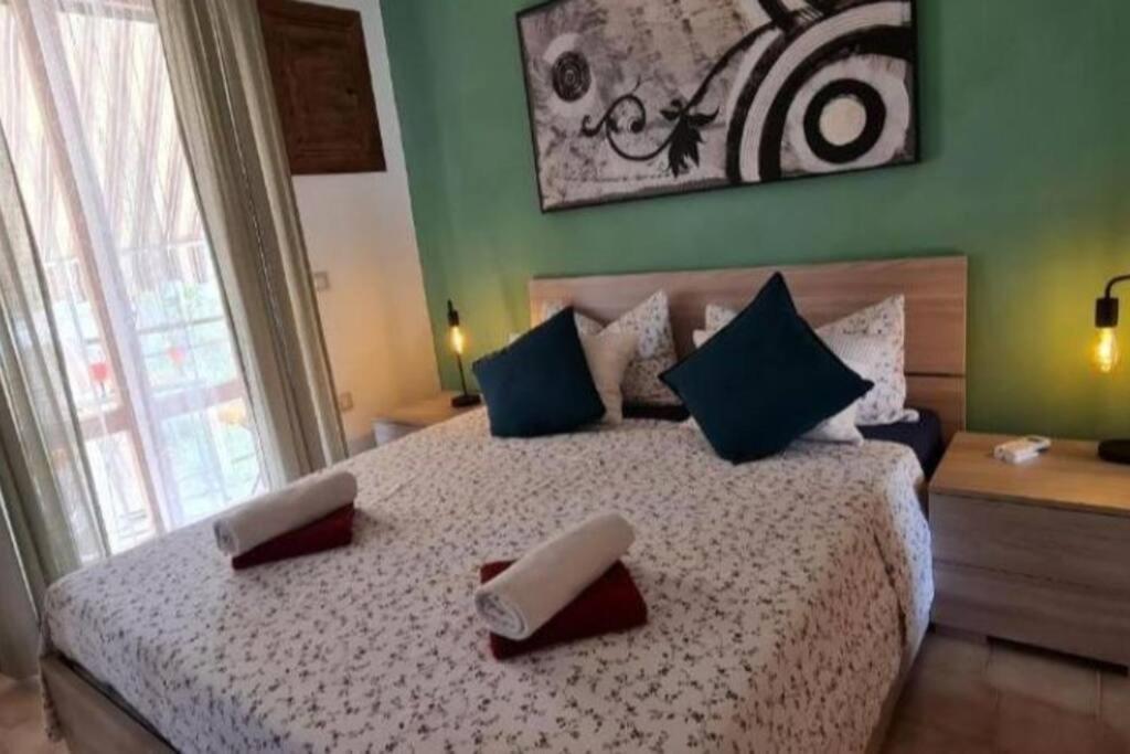 a bedroom with a bed with two pillows on it at Little Home in Bolsena