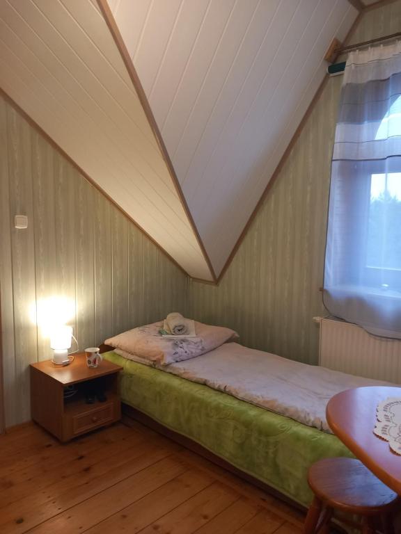 Postel nebo postele na pokoji v ubytování Agroturystyka Pod Złotą Wiechą
