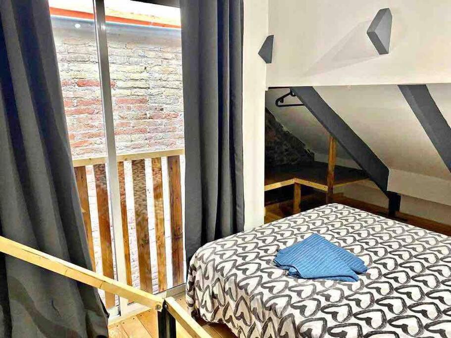 a small bed in a room with a window at L5 Duplex studio with balcony! 2`from the metro in Barcelona