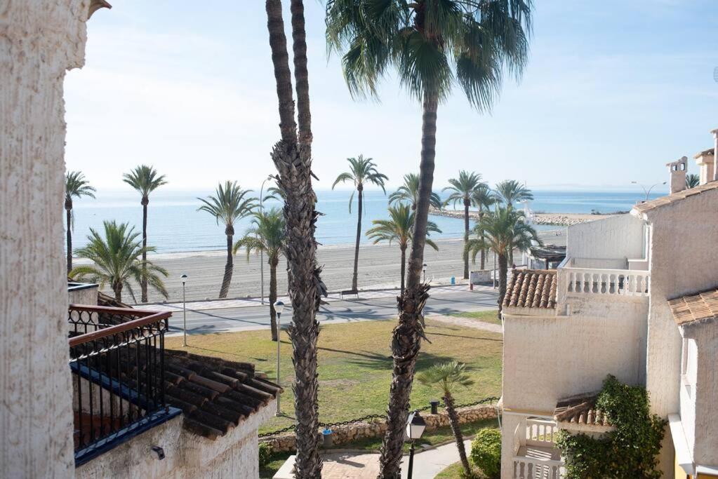 a view of the beach from a building with palm trees at Casa Vistamar Varadero in Santa Pola