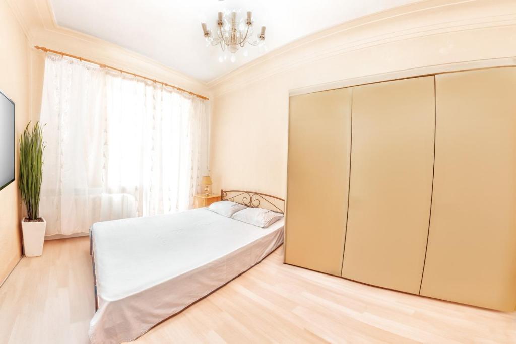 a bedroom with a bed and a large closet at Европейская 17 Мост сити Центр in Dnipro