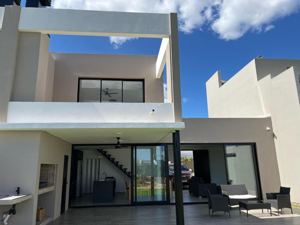 a house with glass doors and a patio at Lago Santa Ana in Santa Ana