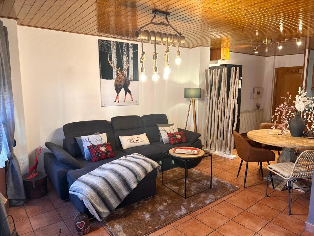 a living room with a couch and a table at Duplex a la plaça Major in El Pont de Suert