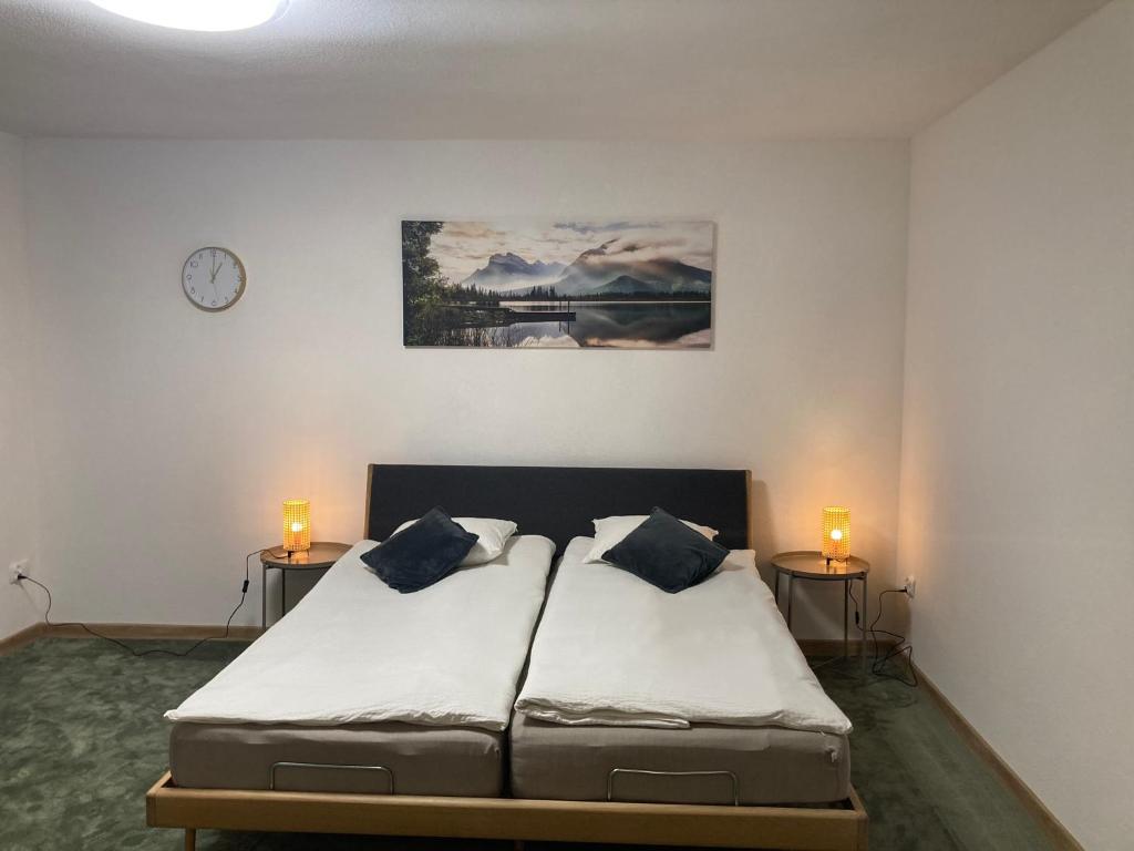 a bedroom with a bed with two lamps on two tables at METRO APARTMENT in Bielsko-Biała