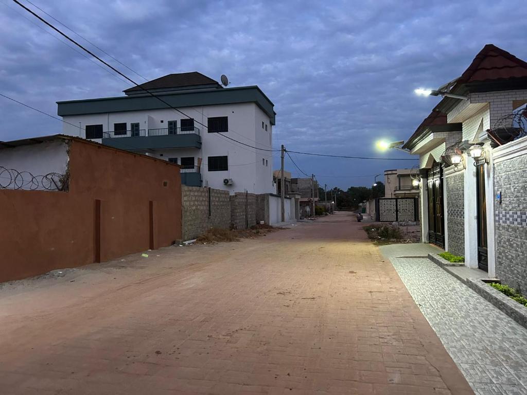 an empty street with a building and a fence at CASA de JAJA 