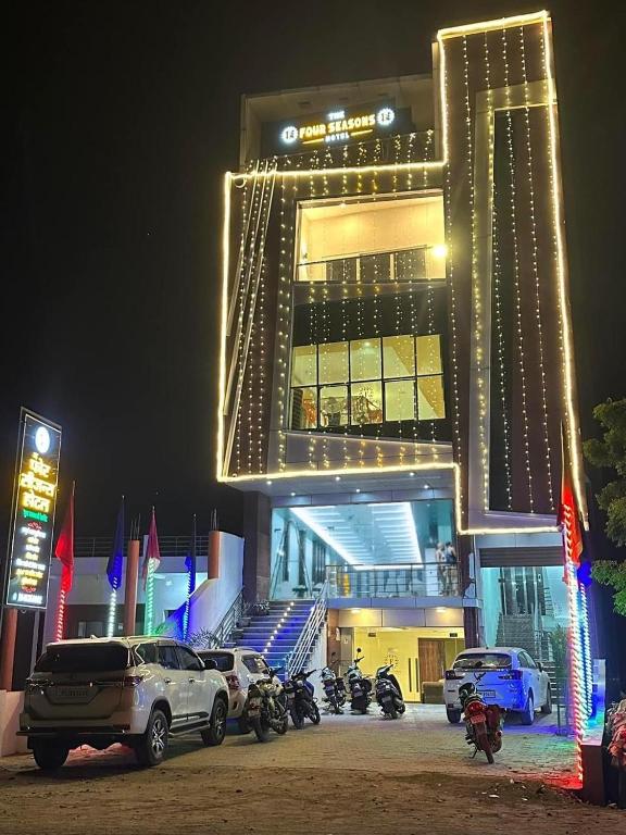 a building with cars parked in front of it at night at The Four Seasons Hotel in Sultānpur