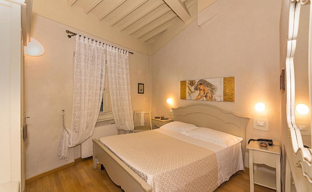 Postel nebo postele na pokoji v ubytování Residenza d'Epoca Relais I Miracoli
