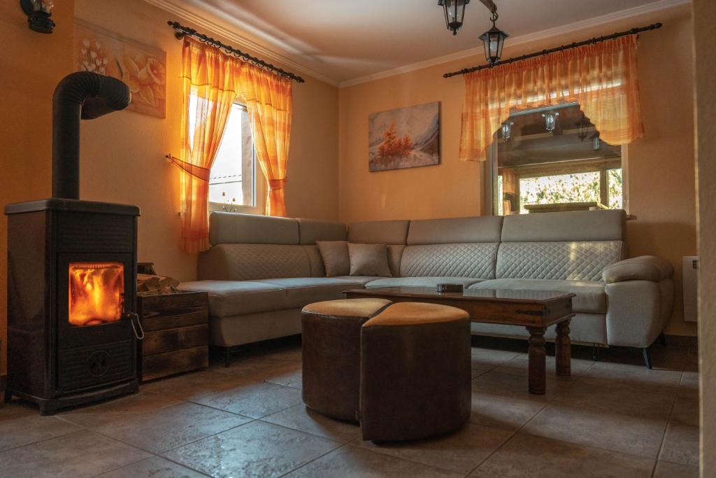 a living room with a couch and a wood stove at Mountain House Skimont, Blidinje in Blidinje