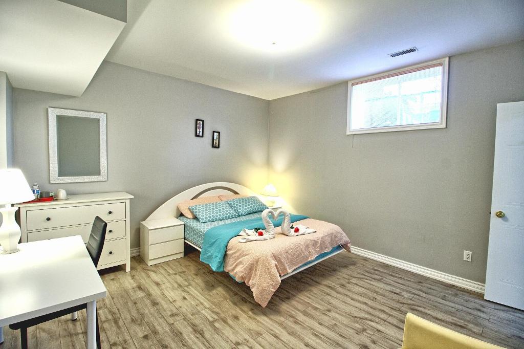 a bedroom with a bed and a desk and a window at Bright Basement & Private Bathroom, free Parking in Vaughan