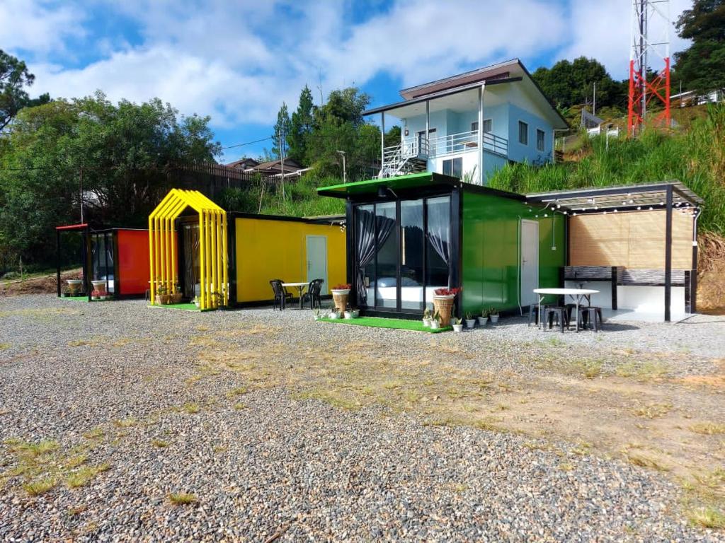 a group of colorful buildings with a house at SF Homestay in Kampong Kundassan