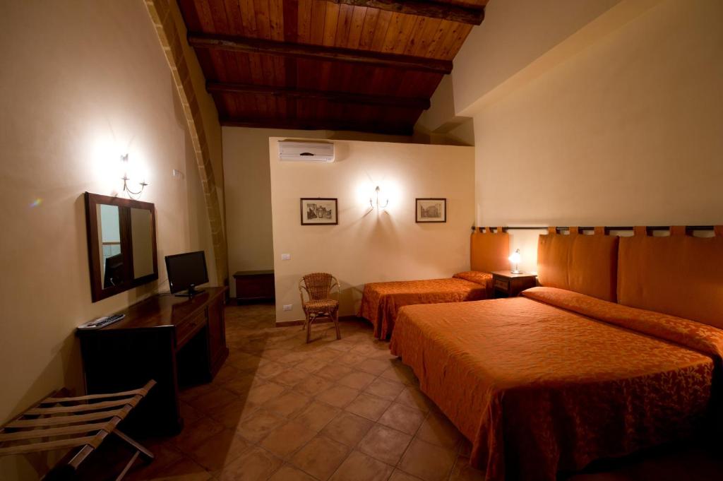 Posteľ alebo postele v izbe v ubytovaní Baglio Cudia Resort