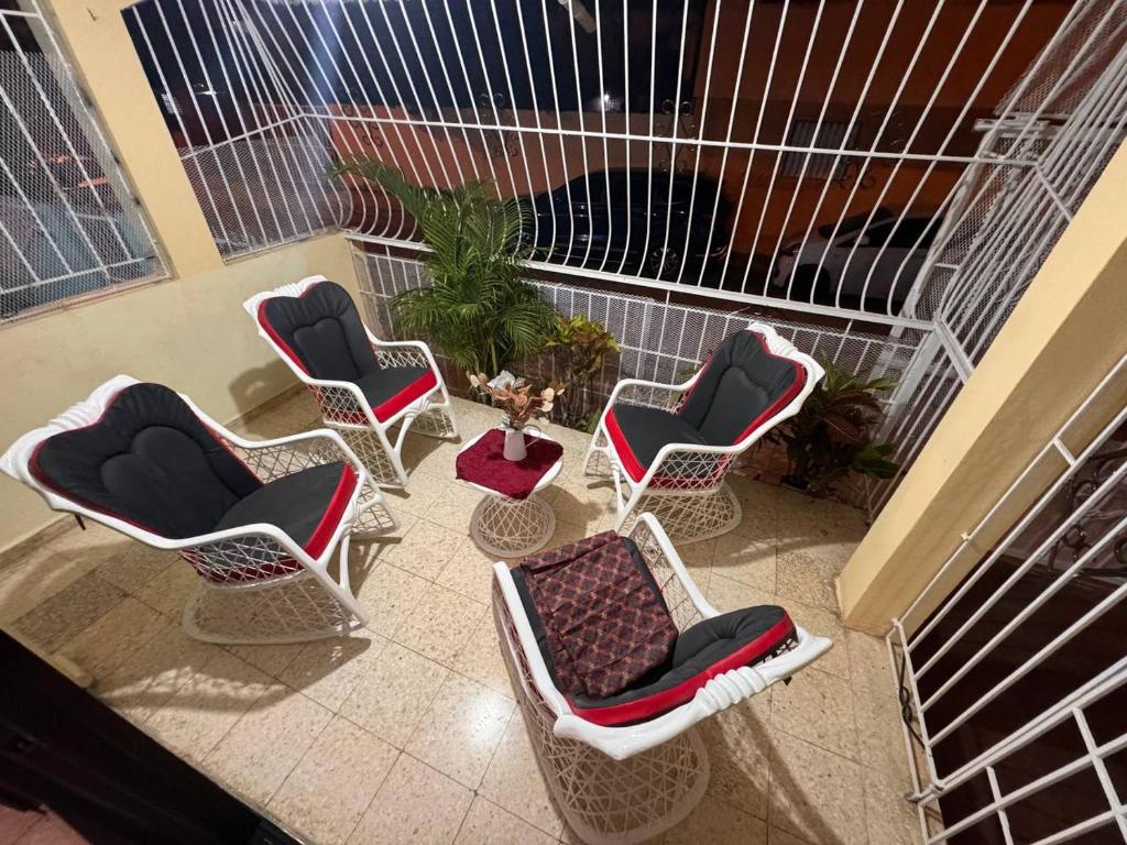 a group of chairs sitting on a balcony at Residencia Foreman De La Paz in Santo Domingo