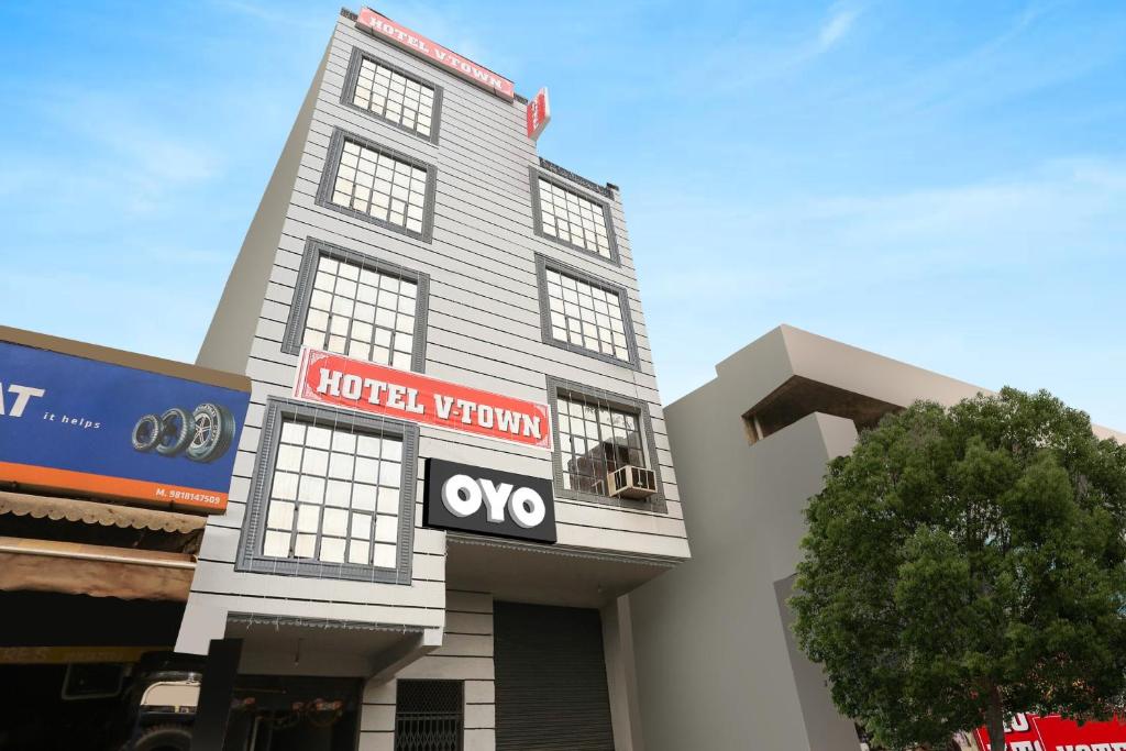 a hotelium building with an ovo sign on it at OYO Flagship Hotel V Town in New Delhi