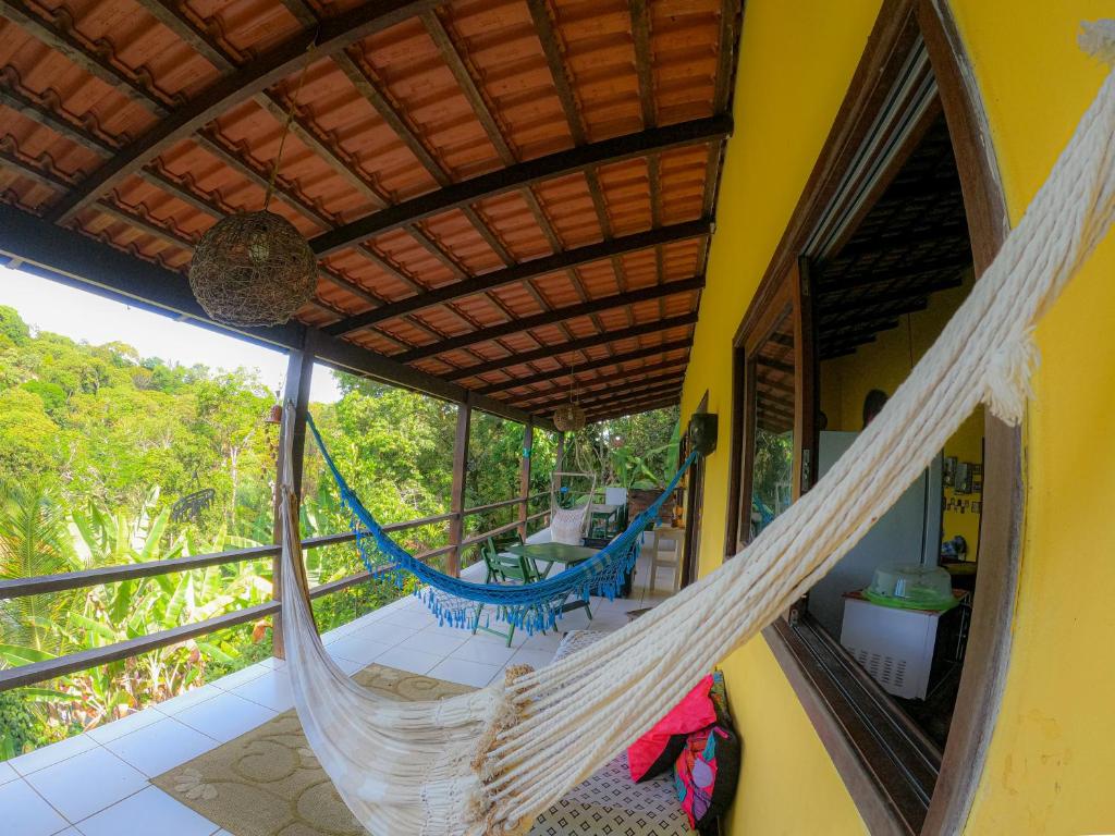 a hammock on the balcony of a house at Hostel Alto Astral - Lagoa in Morro de São Paulo
