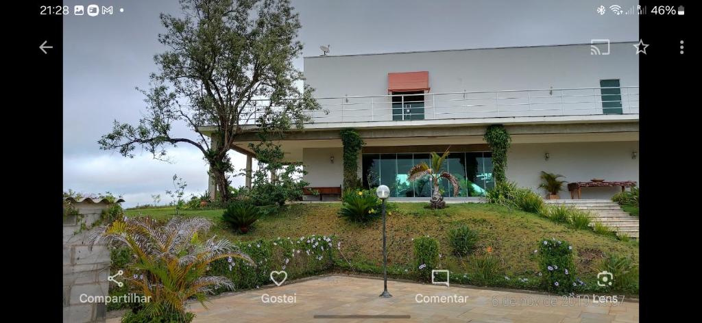 a house with a garden in front of it at Sítio Santa Cecília in Itapetininga