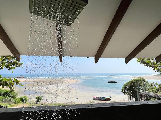 a view of a beach from a window at C Beyond Nilaveli in Nilaveli