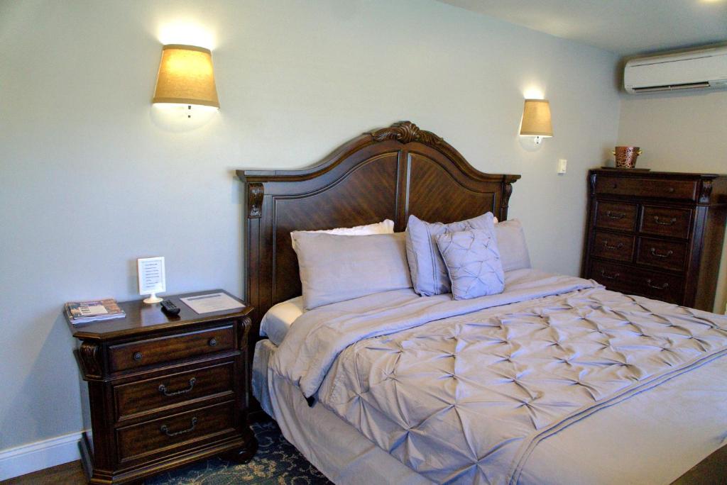 a bedroom with a large bed and a night stand at Cameron Estate Inn in Mount Joy