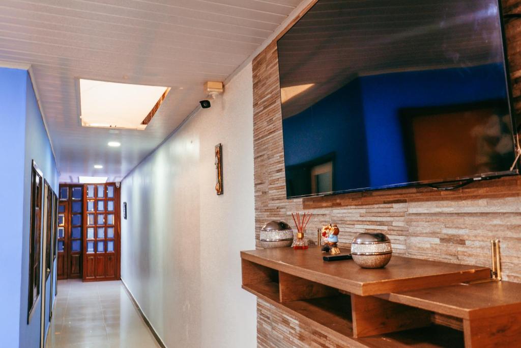 a hallway with a wooden counter and a blue wall at CASA GOMEZ in Leticia