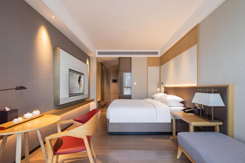 Postel nebo postele na pokoji v ubytování Echeng Hotel - Huawei Base Store in Shenzhen