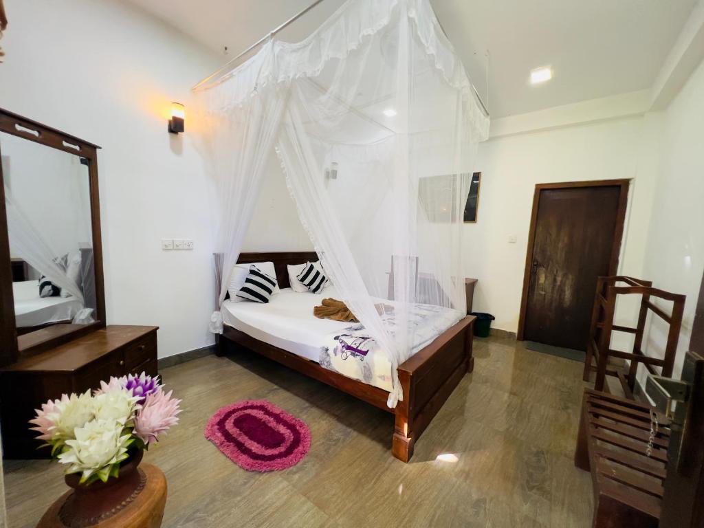 a bedroom with a bed with a mosquito net at Citadel of Dreams Ella in Ella