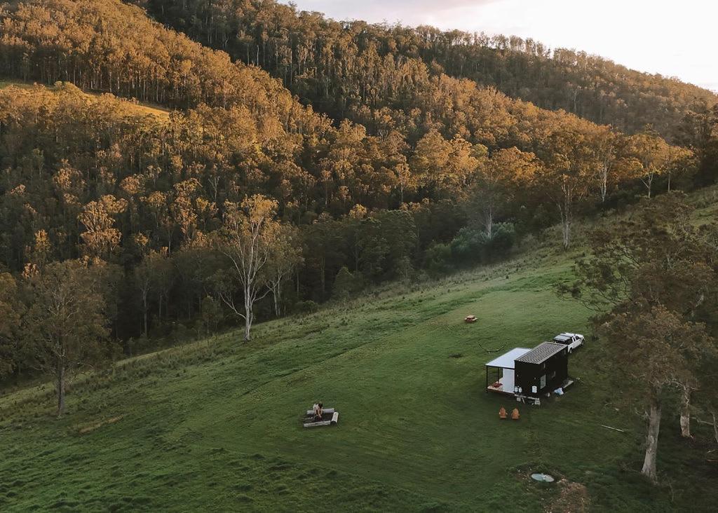 an aerial view of a grassy field with a house at Tiny Zoe in Mount George