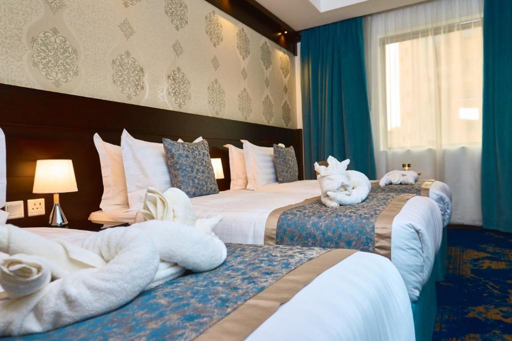 Postel nebo postele na pokoji v ubytování Selat Al Bait Hotel